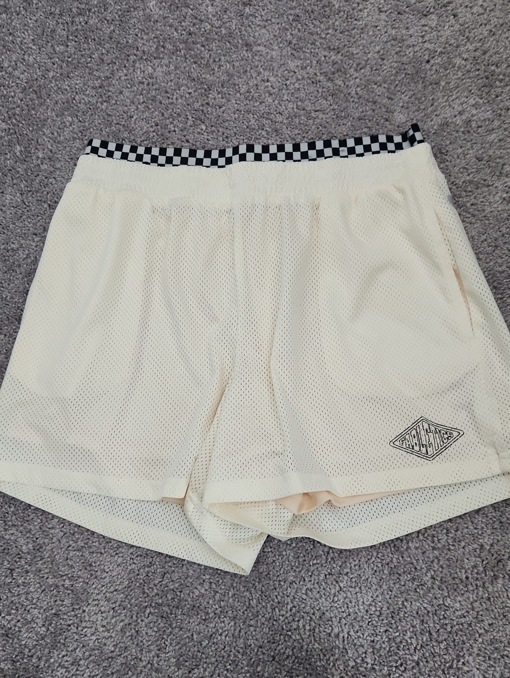 Fabletics Cream Athletic Mesh Shorts with Black Check Waistband